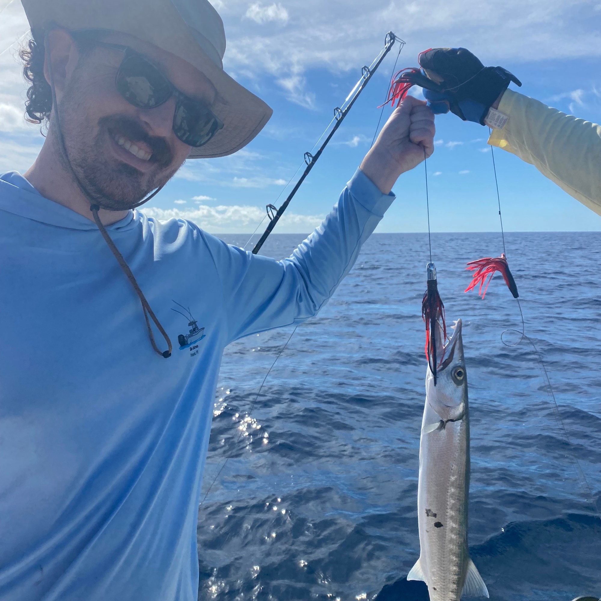 Man holding a barracuda on a Vieques fishing charter