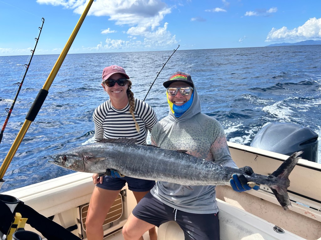 a couple holding a 60 pound Wahoo on a Vieques Charter with Vieques Blue Water Charters